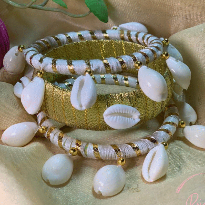 Handmade white and gold cowrie shell bangles set by Rojonika